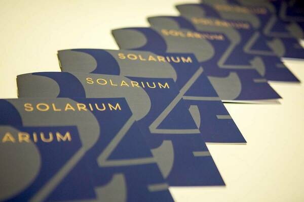 Solarium 24 show booklets arranged on a table.